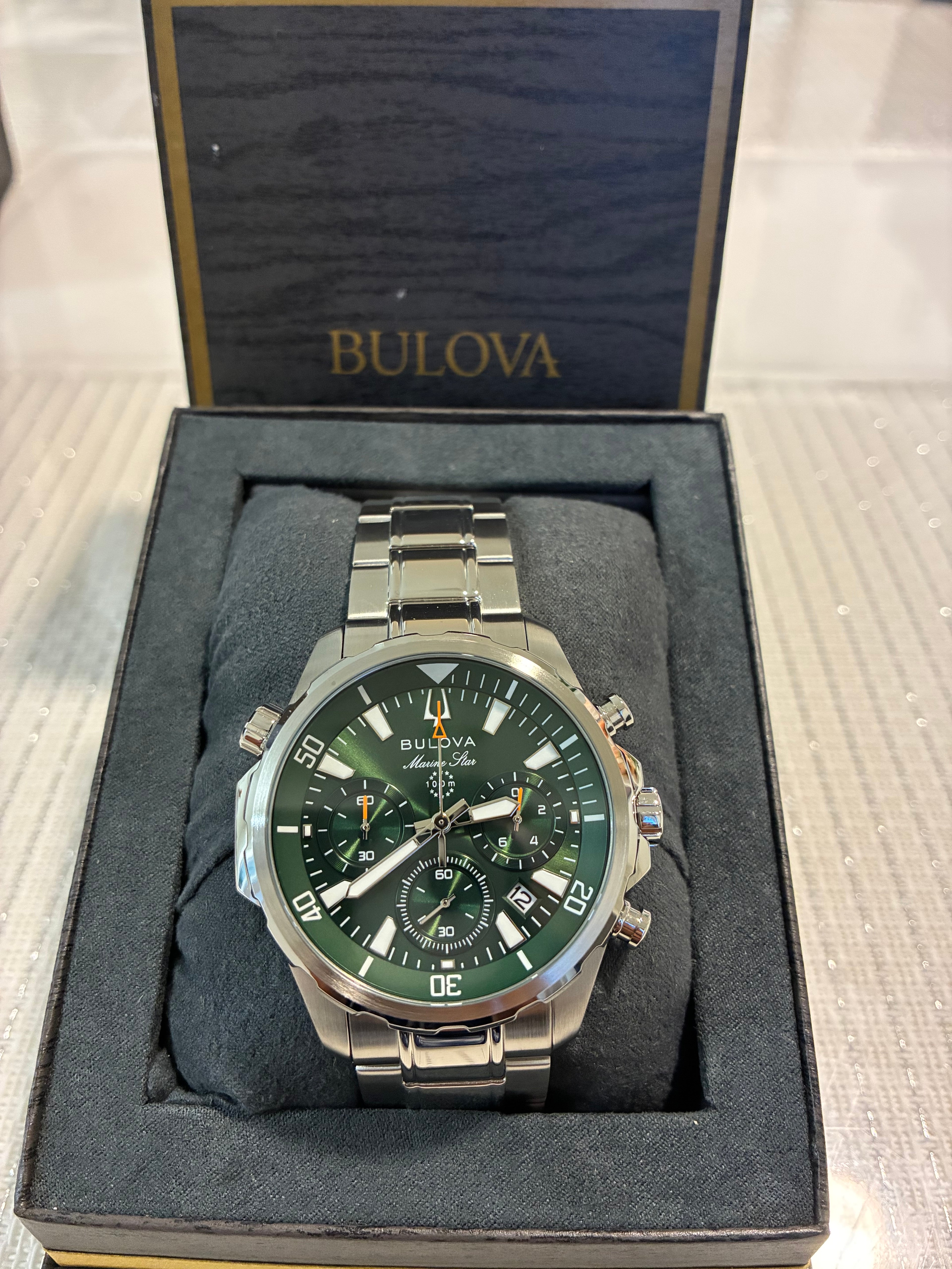 Bulova Marine Star (model 96B396) features a striking green dial housed in a durable stainless steel case.